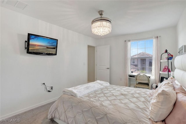 carpeted bedroom with baseboards, visible vents, and a notable chandelier