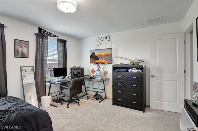 carpeted bedroom featuring visible vents