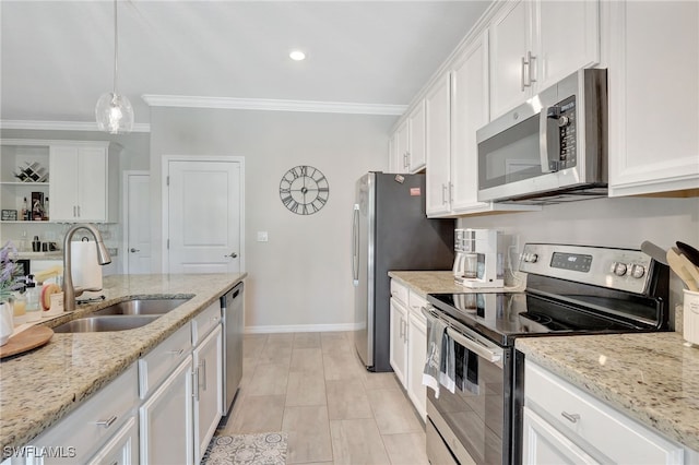 kitchen with a sink, appliances with stainless steel finishes, ornamental molding, and white cabinetry