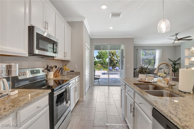 kitchen featuring crown molding, visible vents, white cabinets, a sink, and stainless steel appliances