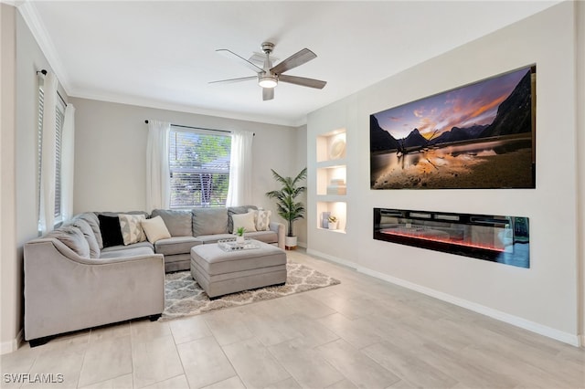 living area featuring crown molding, a ceiling fan, baseboards, and a glass covered fireplace