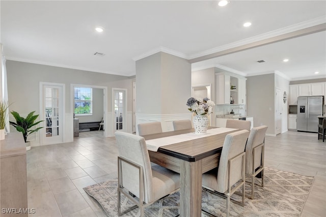 dining room featuring wainscoting, recessed lighting, visible vents, and ornamental molding