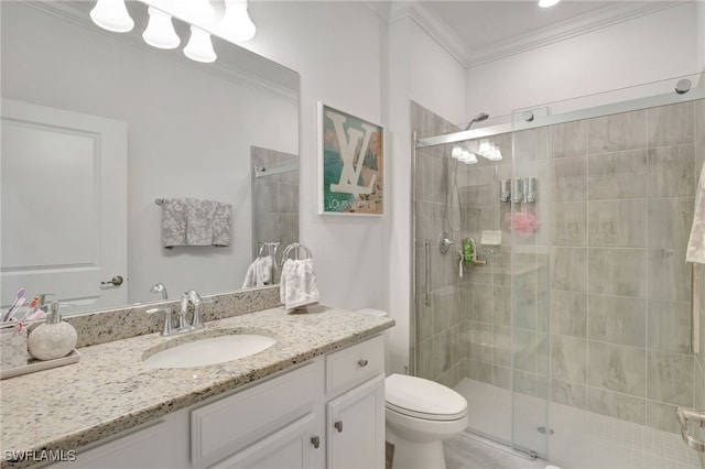 full bathroom featuring vanity, ornamental molding, a stall shower, and toilet
