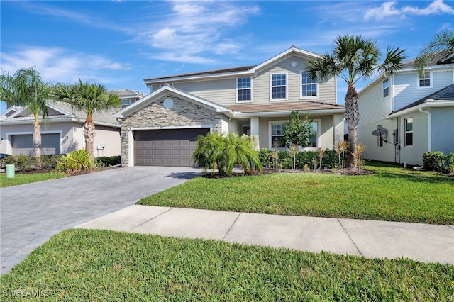 traditional home with driveway, a front lawn, stone siding, and a garage
