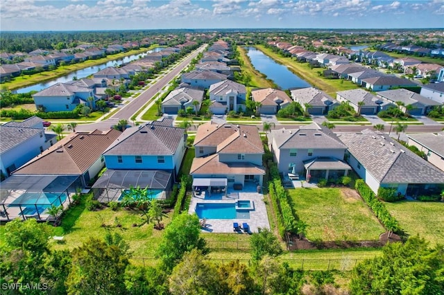 drone / aerial view with a residential view and a water view