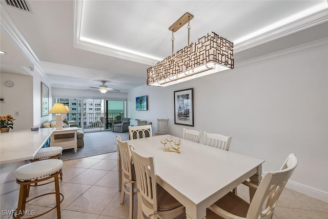3443 Gulf Shore Blvd N Unit 403, Naples, FL 34103 - dining area with visible vents, ornamental molding, ceiling fan, a raised ceiling, and light tile patterned floors