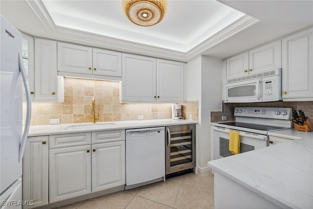 3443 Gulf Shore Blvd N Unit 403, Naples, FL 34103 - kitchen featuring white appliances, a tray ceiling, a sink, and wine cooler