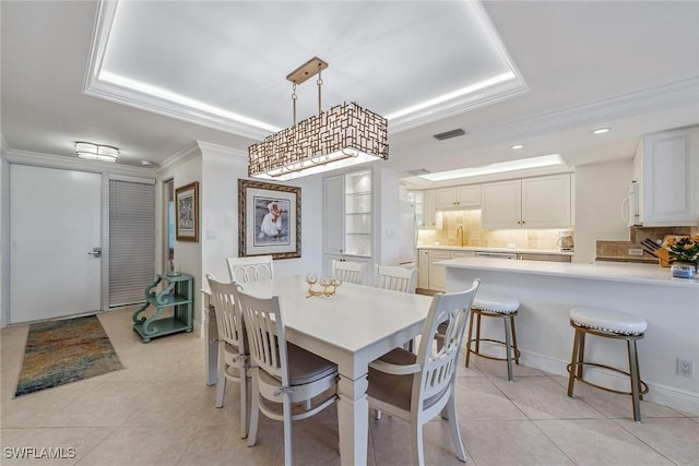 3443 Gulf Shore Blvd N Unit 403, Naples, FL 34103 - dining room featuring ornamental molding, a tray ceiling, light tile patterned flooring, and visible vents