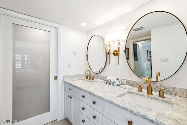 3443 Gulf Shore Blvd N Unit 403, Naples, FL 34103 - bathroom featuring double vanity, visible vents, a sink, and recessed lighting