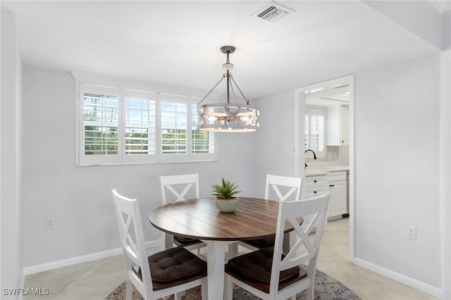 383 Harbour Dr Unit 209, Naples, FL 34103 - dining room featuring a chandelier, baseboards, and light tile patterned floors