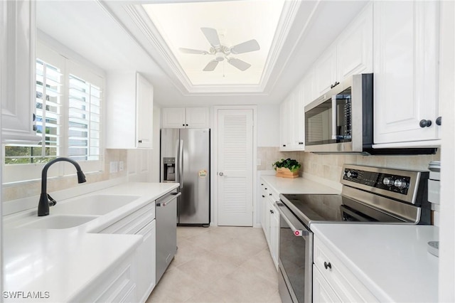 383 Harbour Dr Unit 209, Naples, FL 34103 - kitchen with appliances with stainless steel finishes, a sink, ornamental molding, tasteful backsplash, and a tray ceiling