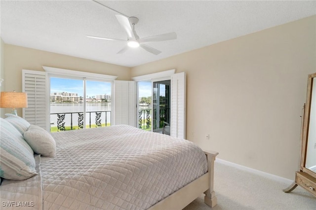 383 Harbour Dr Unit 209, Naples, FL 34103 - bedroom featuring a water view, carpet floors, baseboards, and a ceiling fan
