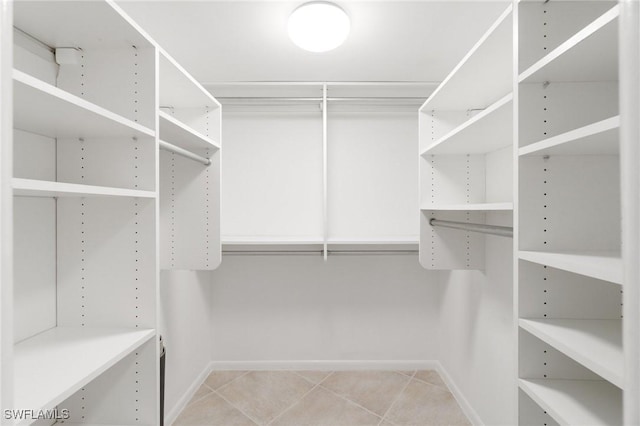 383 Harbour Dr Unit 209, Naples, FL 34103 - walk in closet with light tile patterned floors