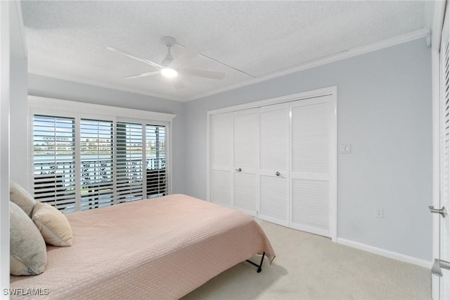 383 Harbour Dr Unit 209, Naples, FL 34103 - bedroom with crown molding, light colored carpet, a textured ceiling, a closet, and a ceiling fan