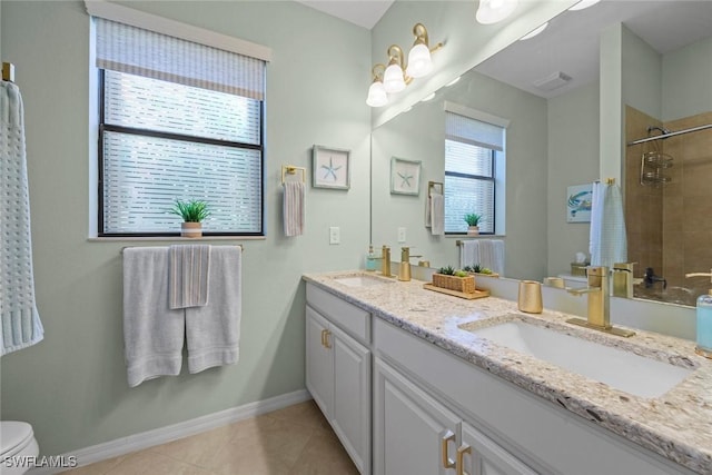20374 Black Tree Ln, Estero, FL 33928 - bathroom featuring toilet, double vanity, tiled shower, baseboards, and tile patterned floors