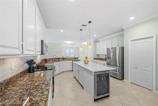 20374 Black Tree Ln, Estero, FL 33928 - kitchen with appliances with stainless steel finishes, beverage cooler, a peninsula, backsplash, and white cabinetry