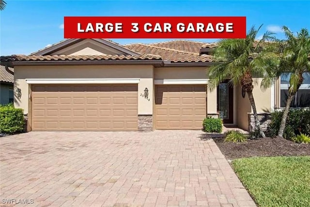 20374 Black Tree Ln, Estero, FL 33928 - mediterranean / spanish-style house with stucco siding, a garage, decorative driveway, and a tile roof