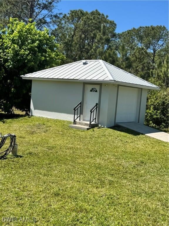 2618 35th Ave NE, Naples, FL 34120 - view of outdoor structure featuring concrete driveway and a garage