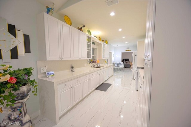 2618 35th Ave NE, Naples, FL 34120 - kitchen featuring white cabinetry, visible vents, light countertops, and marble finish floor