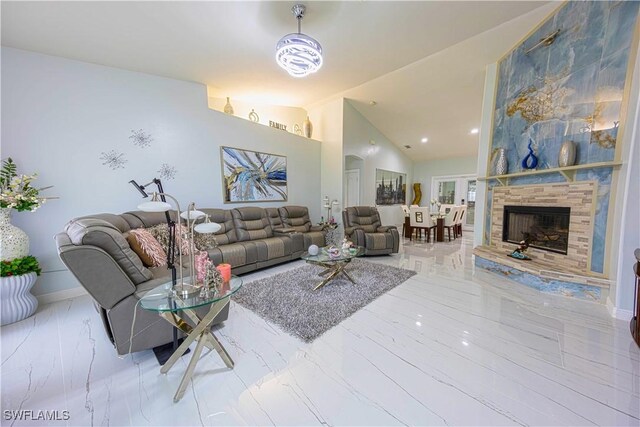 2618 35th Ave NE, Naples, FL 34120 - living area with baseboards, marble finish floor, a fireplace, and vaulted ceiling