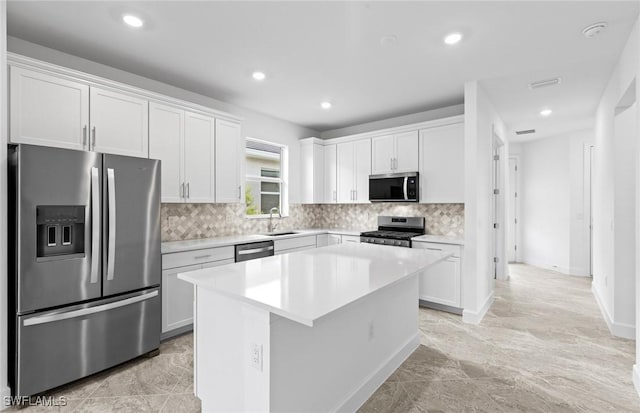 17313 Willow Tree Ln, North Fort Myers, FL 33917 - kitchen featuring stainless steel appliances, a sink, a kitchen island, light countertops, and recessed lighting