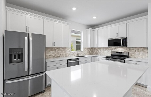 17313 Willow Tree Ln, North Fort Myers, FL 33917 - kitchen with stainless steel appliances, a sink, white cabinetry, recessed lighting, and light countertops