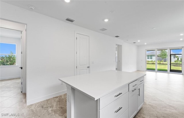 17313 Willow Tree Ln, North Fort Myers, FL 33917 - kitchen featuring plenty of natural light, a center island, recessed lighting, white cabinetry, and light countertops