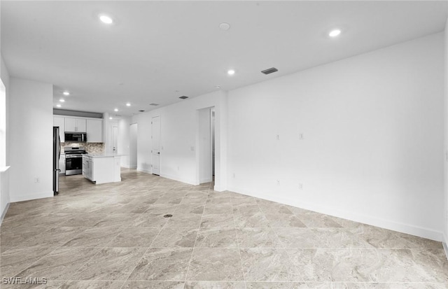 17313 Willow Tree Ln, North Fort Myers, FL 33917 - unfurnished living room with recessed lighting and baseboards