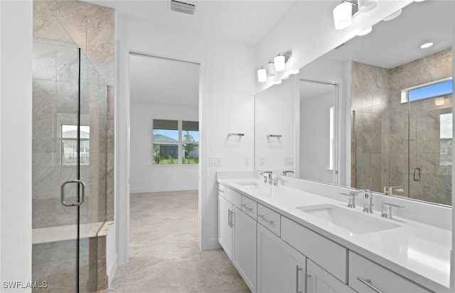 17313 Willow Tree Ln, North Fort Myers, FL 33917 - bathroom featuring a shower stall, double vanity, and baseboards