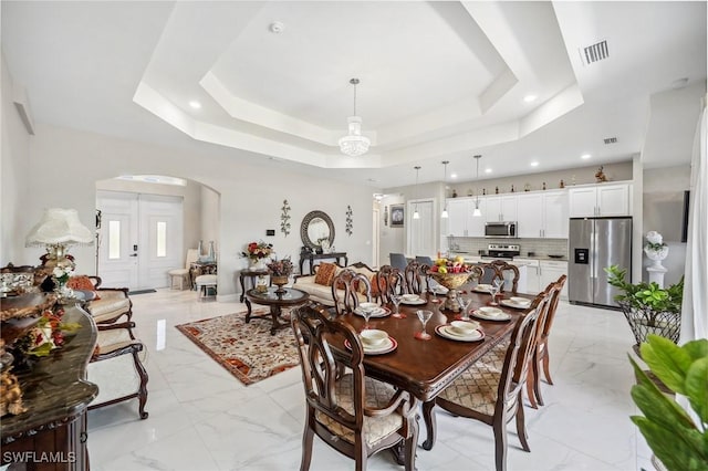 3407 20th St SW, Lehigh Acres, FL 33976 - dining room with a tray ceiling, arched walkways, visible vents, recessed lighting, and marble finish floor