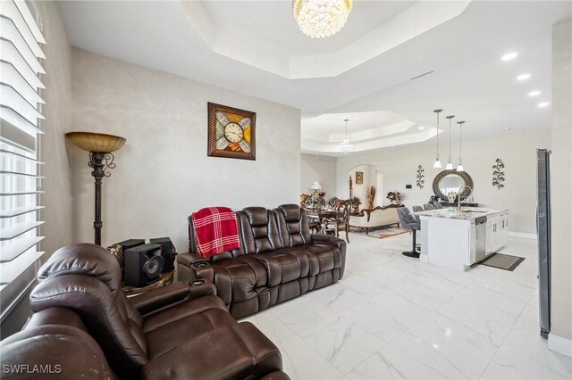 3407 20th St SW, Lehigh Acres, FL 33976 - living room with a raised ceiling, marble finish floor, a chandelier, and recessed lighting