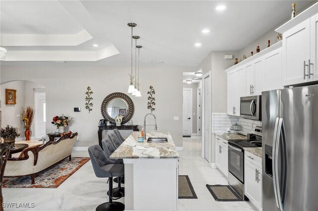 3407 20th St SW, Lehigh Acres, FL 33976 - kitchen with arched walkways, marble finish floor, a sink, and appliances with stainless steel finishes