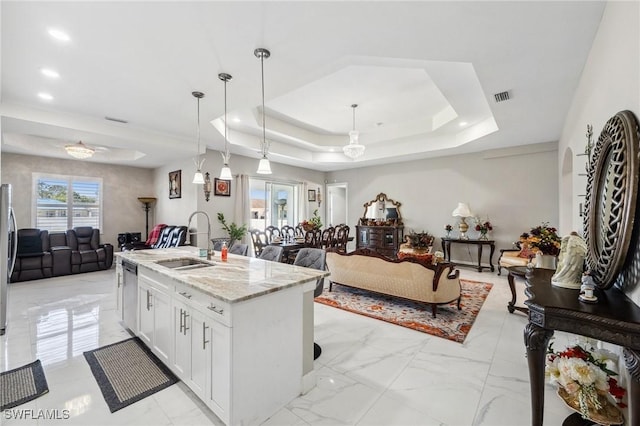 3407 20th St SW, Lehigh Acres, FL 33976 - kitchen with a tray ceiling, marble finish floor, a sink, stainless steel appliances, and open floor plan