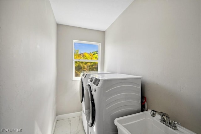 3407 20th St SW, Lehigh Acres, FL 33976 - laundry room with baseboards, washer and dryer, a sink, laundry area, and marble finish floor