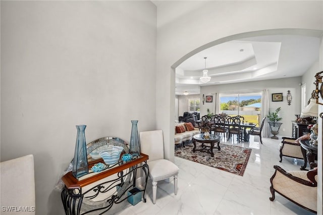 3407 20th St SW, Lehigh Acres, FL 33976 - interior space featuring a tray ceiling, arched walkways, and marble finish floor