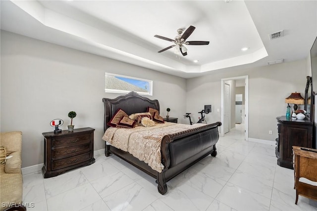 3407 20th St SW, Lehigh Acres, FL 33976 - bedroom with marble finish floor, visible vents, a tray ceiling, and baseboards
