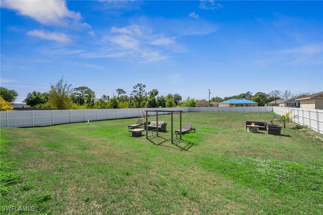 3407 20th St SW, Lehigh Acres, FL 33976 - view of yard featuring a fenced backyard and an outdoor fire pit