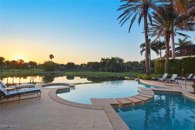 view of swimming pool with a pool with connected hot tub and a patio