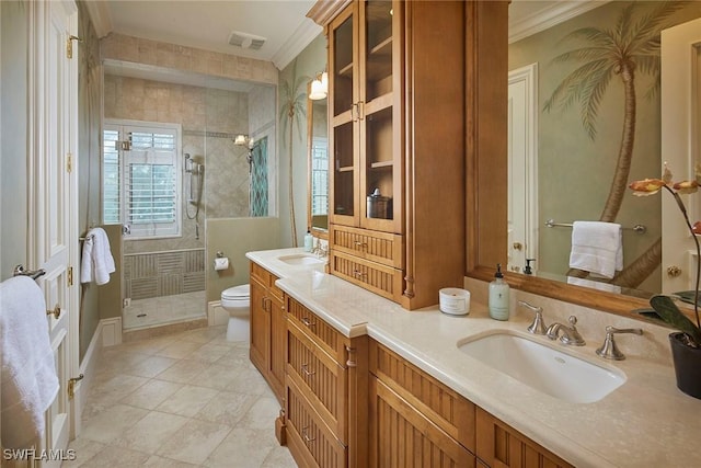 bathroom with visible vents, a sink, toilet, and a stall shower
