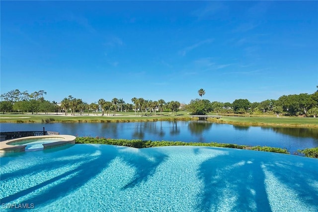 view of pool with a pool with connected hot tub and a water view