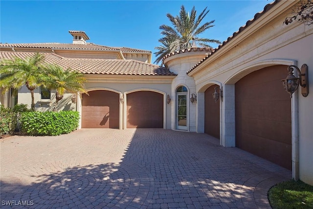 garage featuring decorative driveway