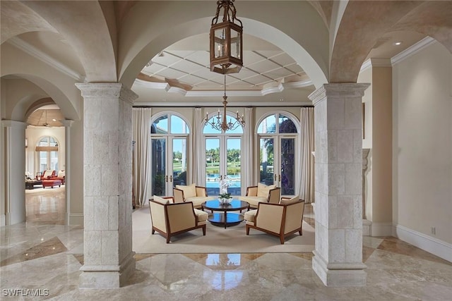 entryway featuring decorative columns, marble finish floor, arched walkways, and a wealth of natural light
