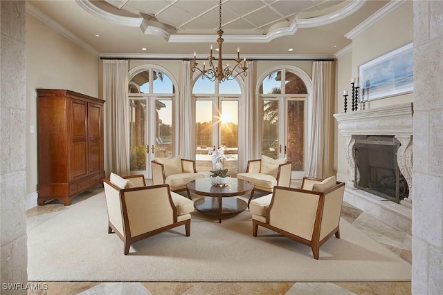 sitting room with a chandelier, crown molding, a fireplace with raised hearth, recessed lighting, and a high ceiling