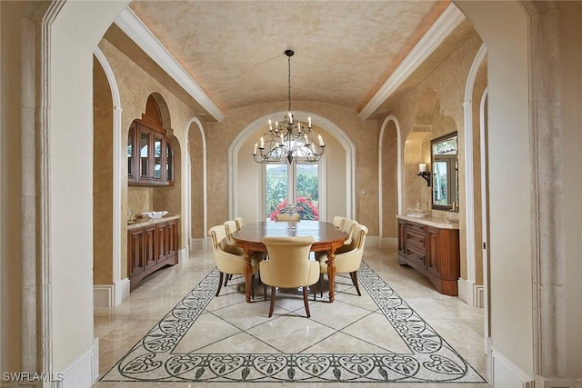 dining room featuring arched walkways, a notable chandelier, baseboards, and lofted ceiling
