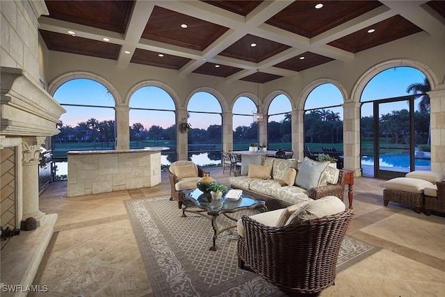 patio terrace at dusk with outdoor lounge area and a lanai