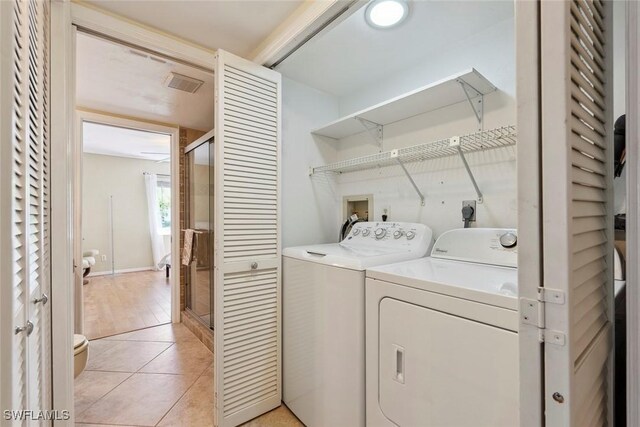 3130 Kings Lake Blvd Unit 7543, Naples, FL 34112 - laundry area with light tile patterned floors, washer and dryer, and visible vents