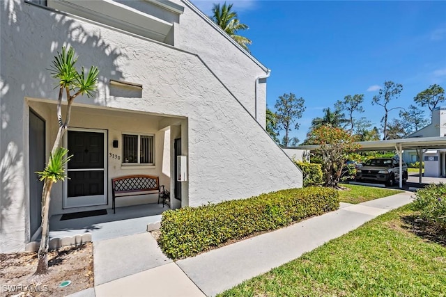 3130 Kings Lake Blvd Unit 7543, Naples, FL 34112 - view of exterior entry with stucco siding