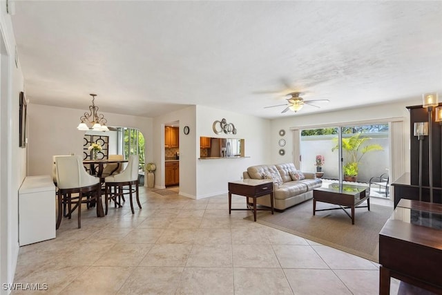 3130 Kings Lake Blvd Unit 7543, Naples, FL 34112 - living room with light tile patterned floors, baseboards, and ceiling fan with notable chandelier