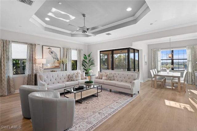 living room featuring healthy amount of natural light, crown molding, a ceiling fan, light wood-type flooring, and recessed lighting