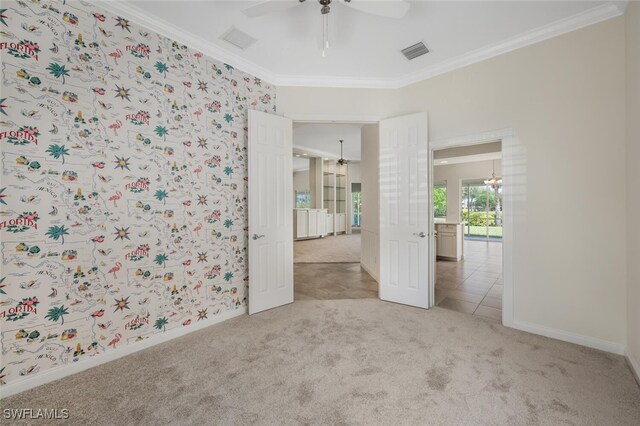 8511 Alessandria Ct, Naples, FL 34114 - spare room featuring light colored carpet, visible vents, crown molding, and a ceiling fan